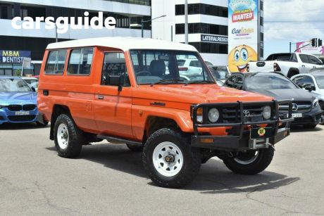 Orange 2001 Toyota Landcruiser Troop Carrier (4X4) 3 Seat