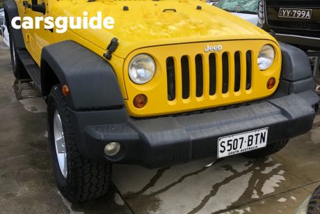 Yellow 2009 Jeep Wrangler Softtop Unlimited Sport (4X4)