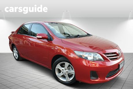 Red 2010 Toyota Corolla Sedan Conquest