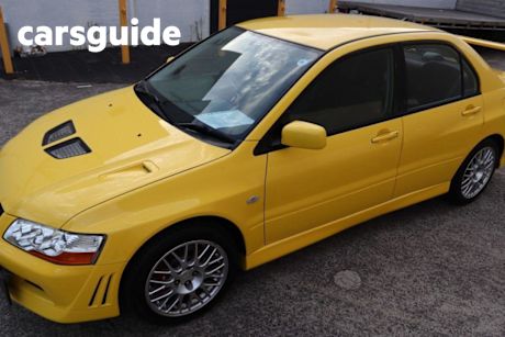 Yellow 2001 Mitsubishi Lancer Sedan Ralliart Evolution VI