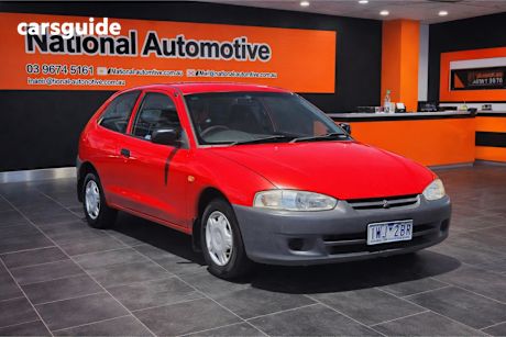Red 2001 Mitsubishi Mirage Hatchback