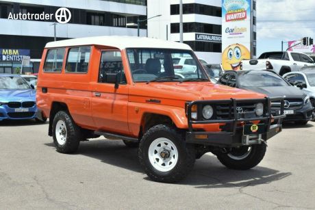 Orange 2001 Toyota Landcruiser Troop Carrier (4X4) 3 Seat